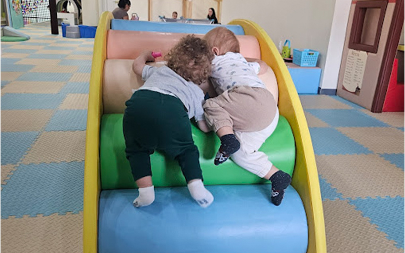 Soft game zone with cushioned climbing frames and padded obstacles.