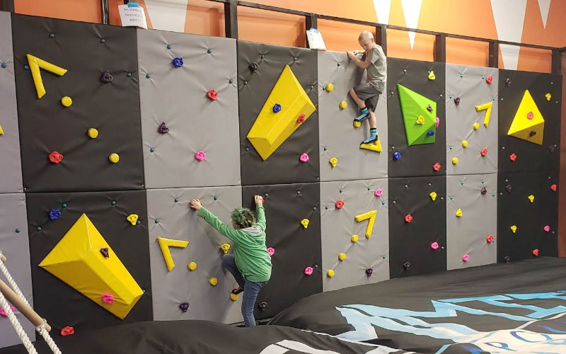 Colorful climbing wall game attracts older children