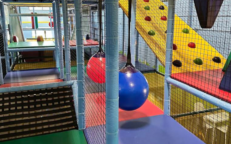 Indoor obstacle game area encouraging active, skill-building play