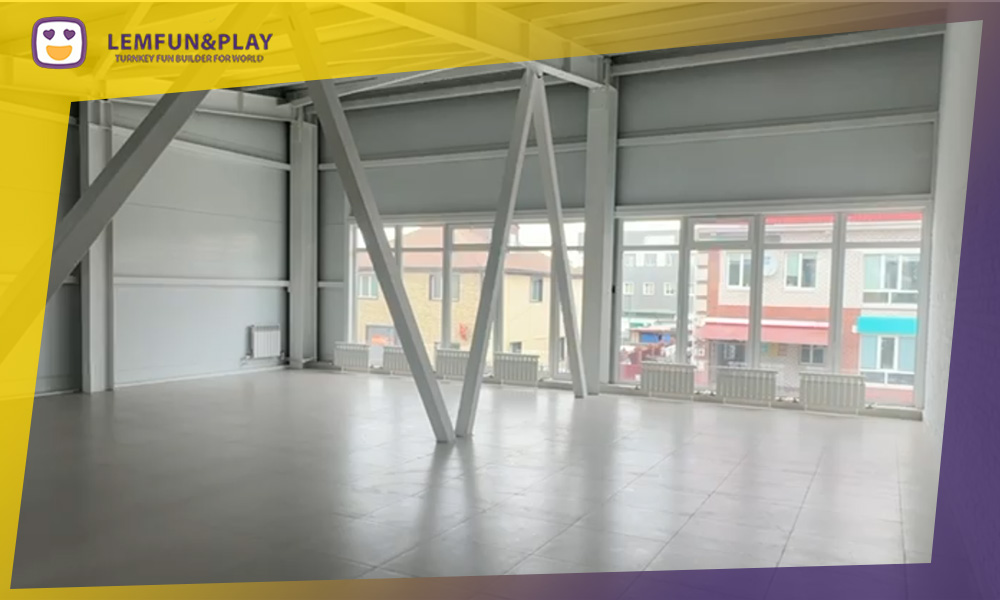 Lemfun project manager Bob reviewing a low ceiling venue floor plan for a new trampoline park project in Canada