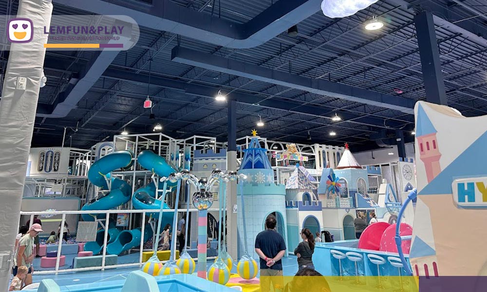 Contrast between 3D design render and actual site construction for a realistic indoor playground business plan.