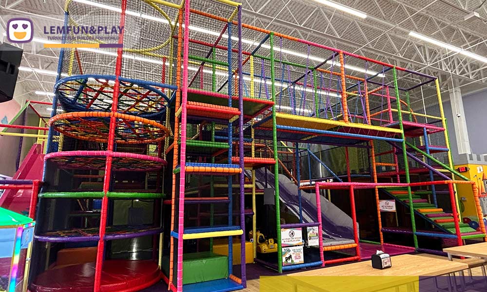 A fully operational, fire-compliant indoor playground in the USA designed by Lemfun, featuring safe soft play equipment and clear emergency exits.