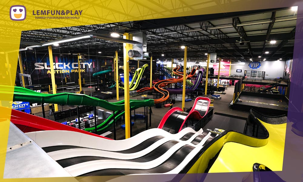 A varied selection of indoor playground slides, including spiral slides, wavy slides, and tube slides, installed in a colorful, themed entertainment center.