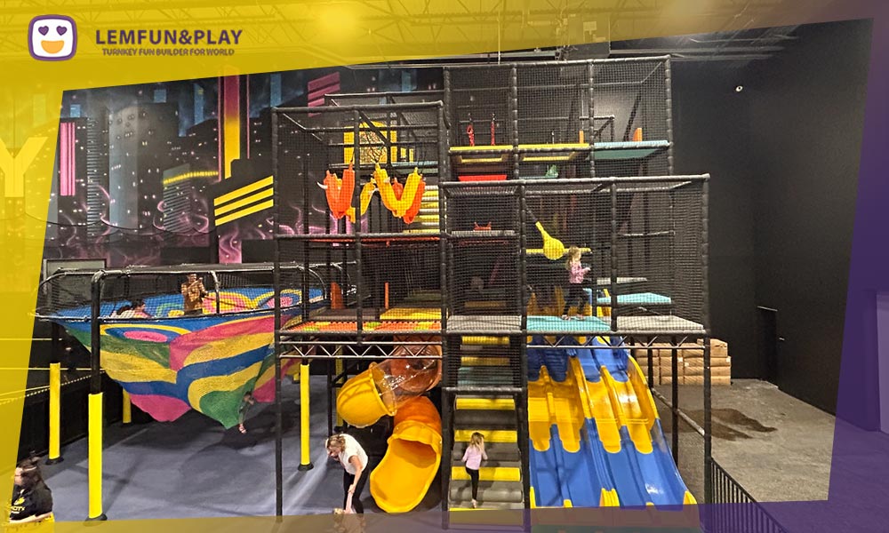 A complex, multi-level indoor playground maze structure featuring climbing tunnels, obstacles, and ball pits, optimized for maximum kids capacity and safety.
