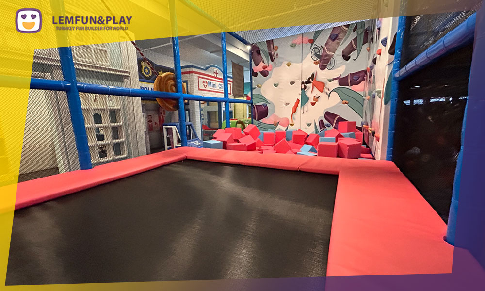Energetic kids trampoline area designed with a candy cloud concept and jelly bean patterns at Little North Playland.
