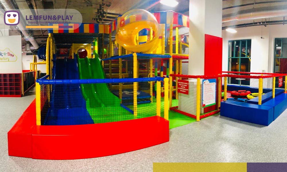 High-density soft playground equipment at Peek-a-Boo Factory SF, including marshmallow-shaped foam bolsters and 