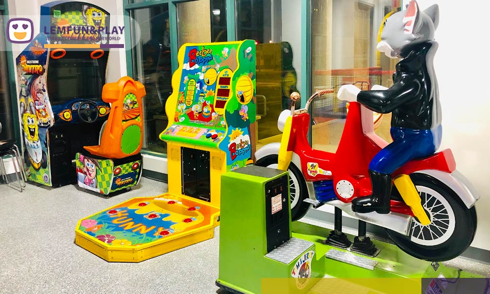 The modern arcade game area at Peek-a-Boo Factory SF, showcasing neon-lit 