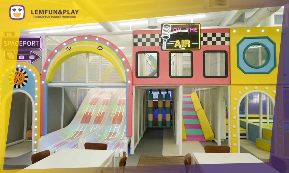 A multi-level commercial indoor soft maze play set with climbing obstacles and safety netting, designed for high-traffic indoor playgrounds.