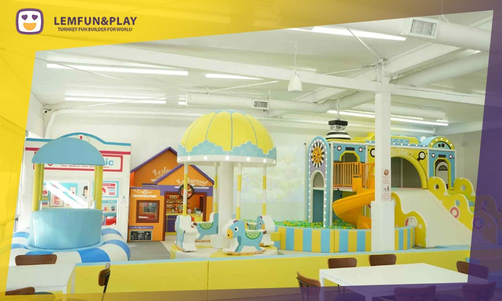 A dedicated soft play toddler zone with low-height climbing blocks and sensory play panels for children under 3 years old.