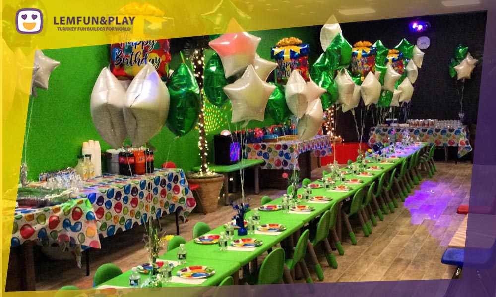 A vibrant jungle-themed kids party area at Jungle Jim and Jane, featuring themed tables and seating integrated with custom indoor play equipment in New Jersey.