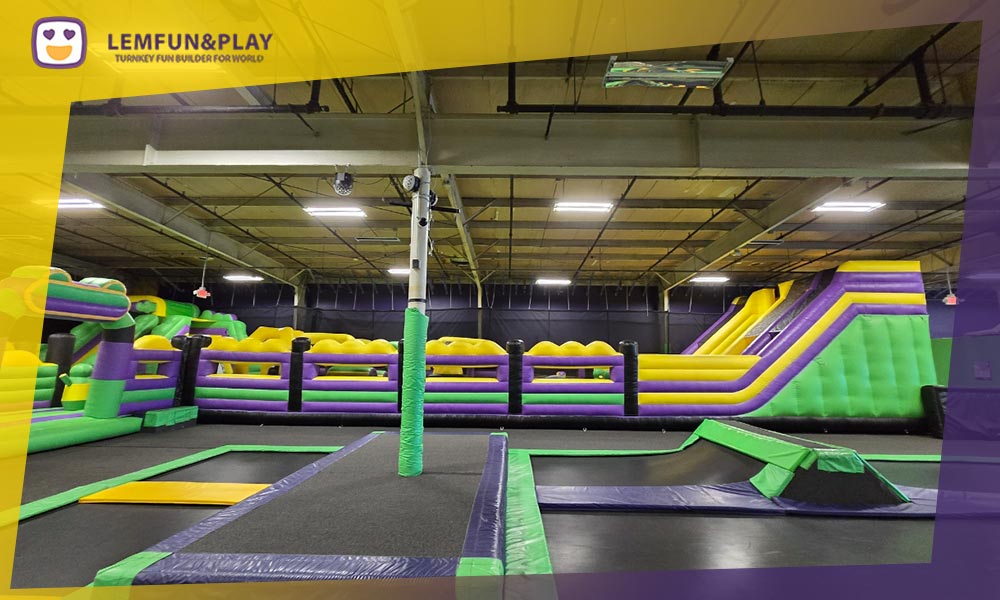 Large-scale commercial inflatable air park area with custom bouncy obstacles for indoor playground centers.