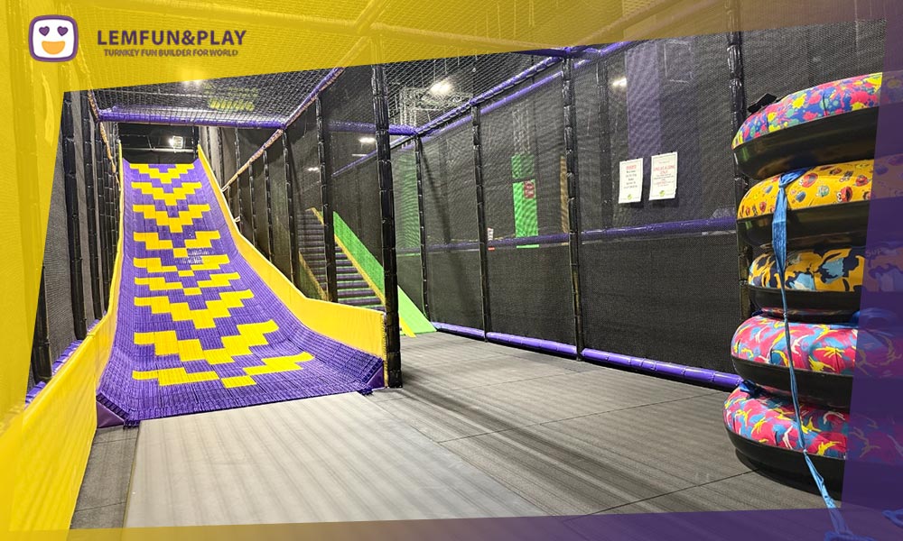High-speed donut slide with rainbow dry-slip track, a high-ROI attraction for modern trampoline parks.