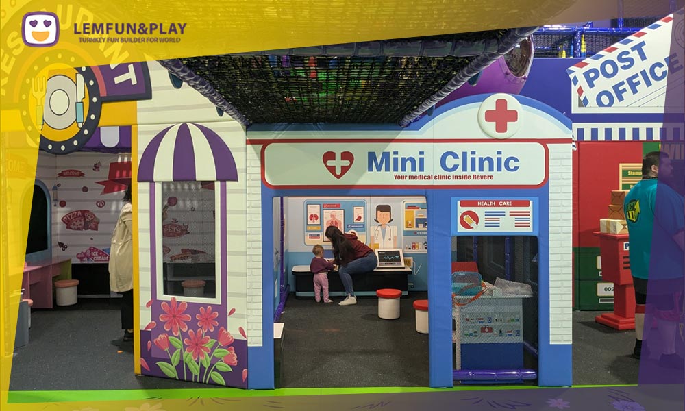 Custom-designed kids role play house featuring mini supermarket and hospital themes for indoor educational play centers.