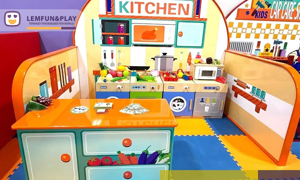 Custom-designed kids role play house with macaroon-themed facades for imaginative play in a commercial indoor playland.