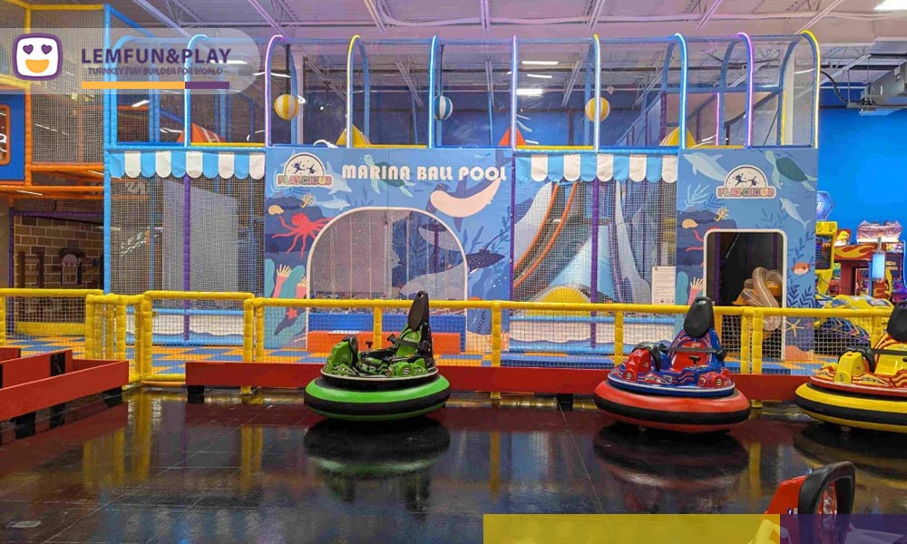 Indoor kids go cart area with pastel-toned safety barriers designed for high-capacity commercial use at Playcious.