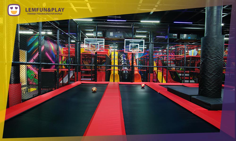 Trampoline basketball slam dunk lanes with commercial-grade hoops, backboards, and protective wall padding.