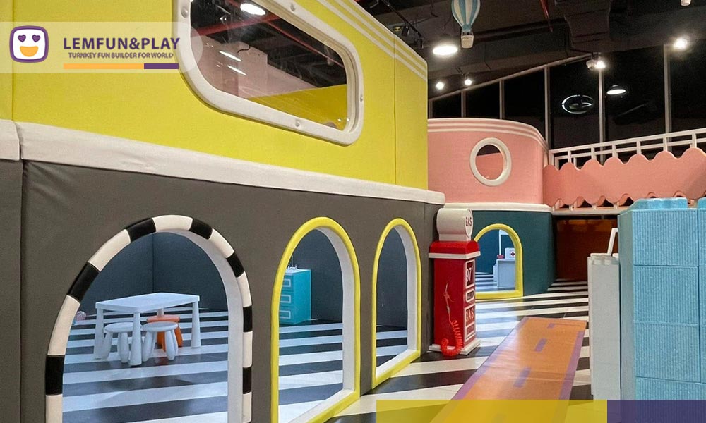 Miniature town layout with high-contrast flooring as part of a custom commercial indoor playpark
