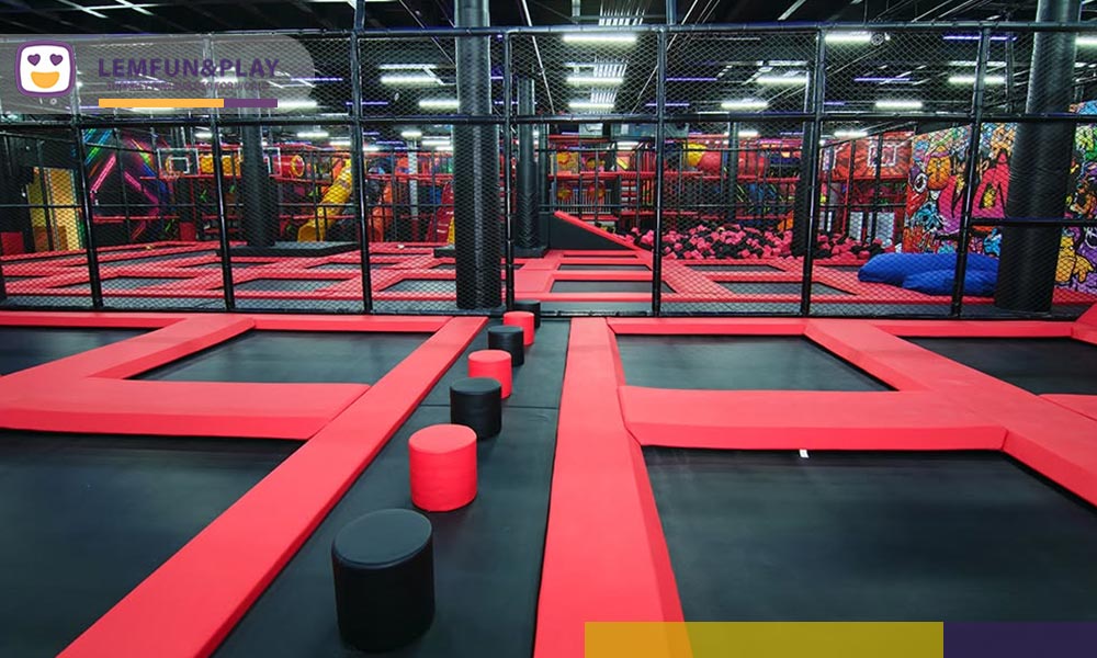 Large free trampoline area featuring custom commercial indoor trampoline park equipment.