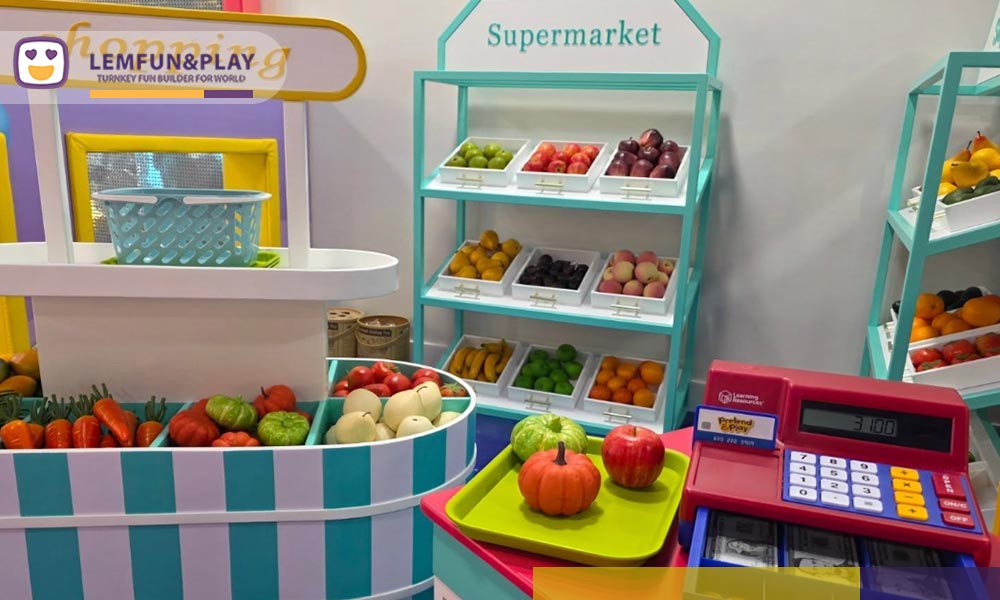 Macaroon-themed kids role play area with a miniature bakery and custom soft-play structures.