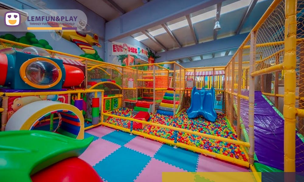 Multi-level maze play area and colorful ball pool in a commercial indoor entertainment center.