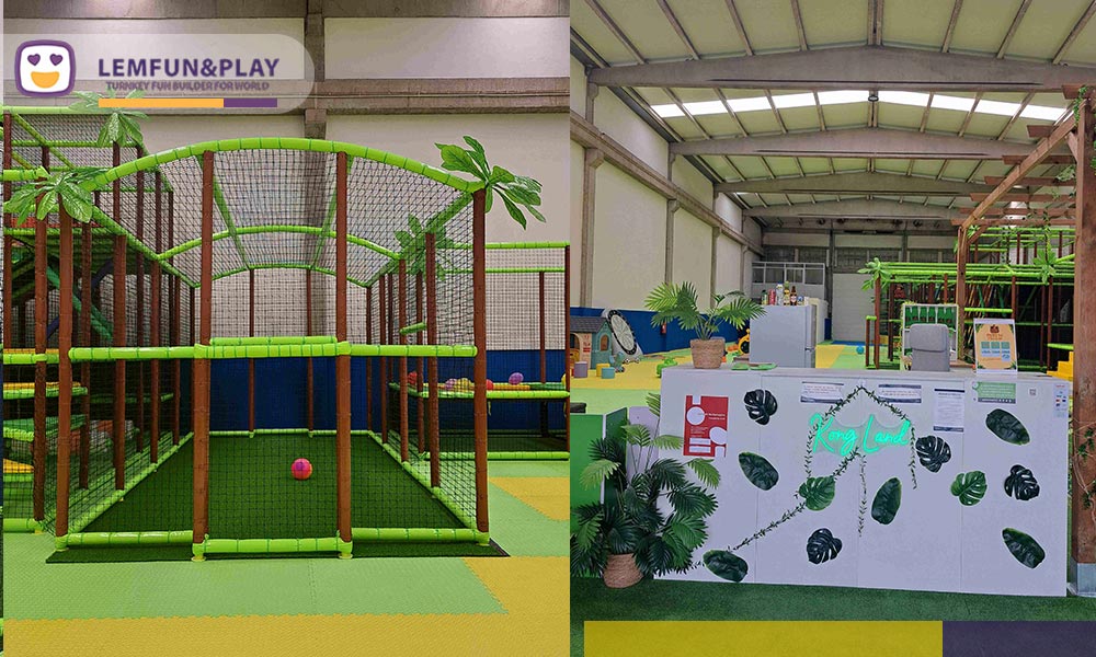 Enclosed interactive football game arena inside Kong Land indoor playground, built with artificial turf and protective safety netting.