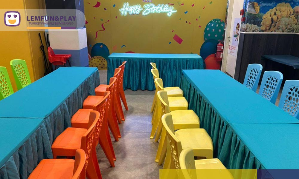 Private birthday party room featuring neon signage and macaroon-colored dining furniture inside Little Pirates Playland at Pavilion Bukit Jalil.