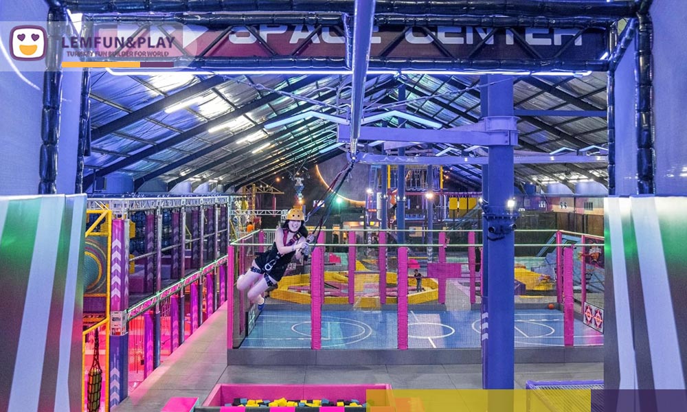 Automated aerial zip-line game gliding over the active sports zones at Aeroxspace Adventure, a premier 600sqm commercial play center showcase in Bali.