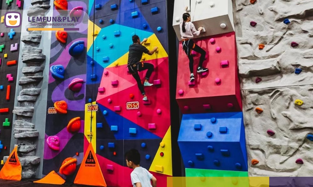 Professional auto-belay rock climbing wall matrix with geometric LED challenge faces and realistic rock textures in Denpasar, Indonesia.